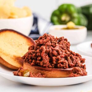 Sloppy Joe sandwich on a white serving plate.