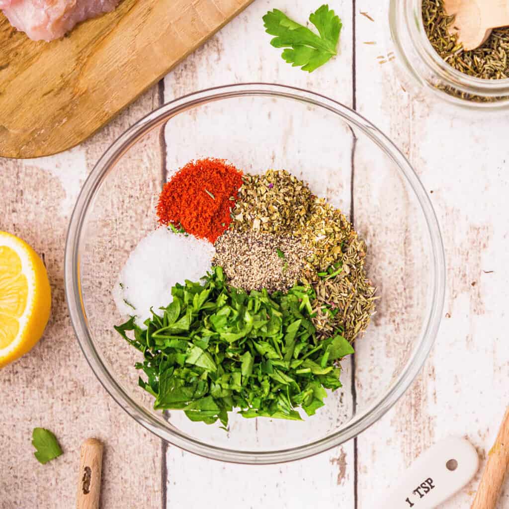 Herbs and spices in a small glass bowl.