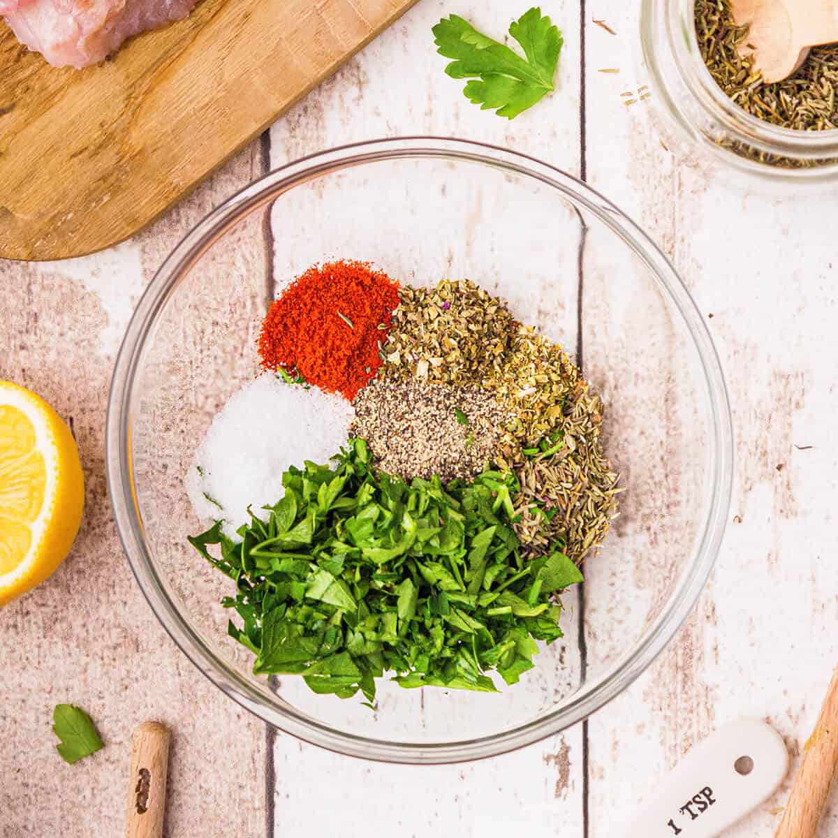 Herbs and spices in a small, clear bowl.