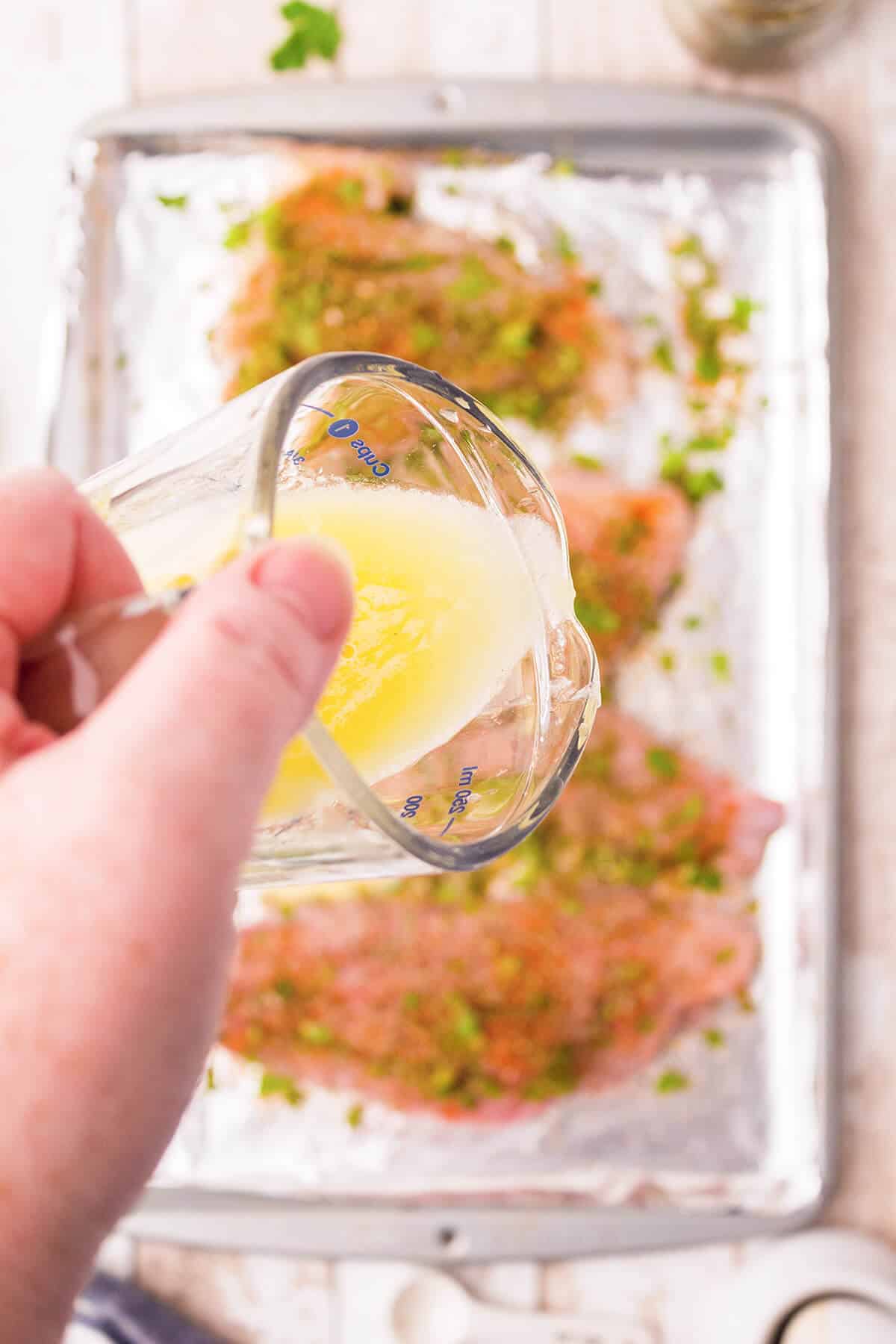 Small cup containing a mixture of melted butter, lemon juice and garlic powder.