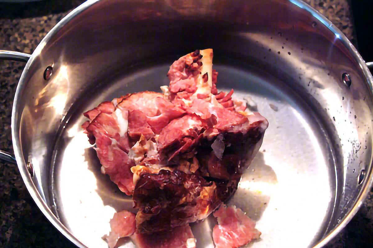 Leftover ham bone in a soup pot.
