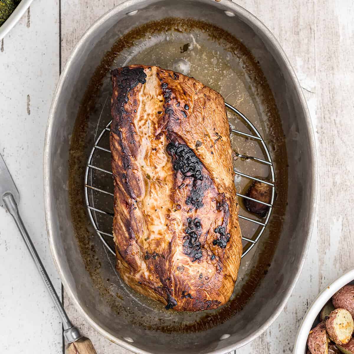 Finished pork loin resting before slicing.