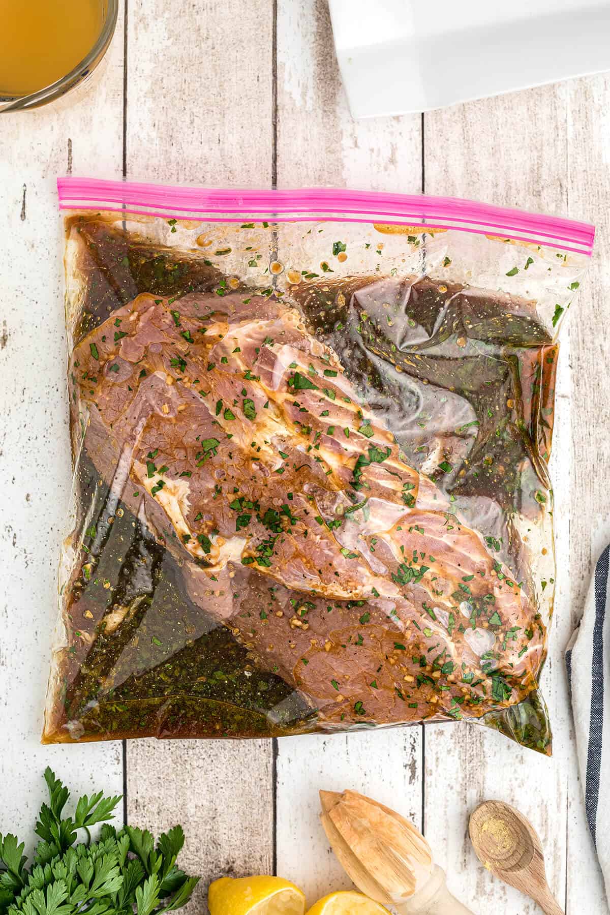 Marinade and pork loin in a large zip-top bag.