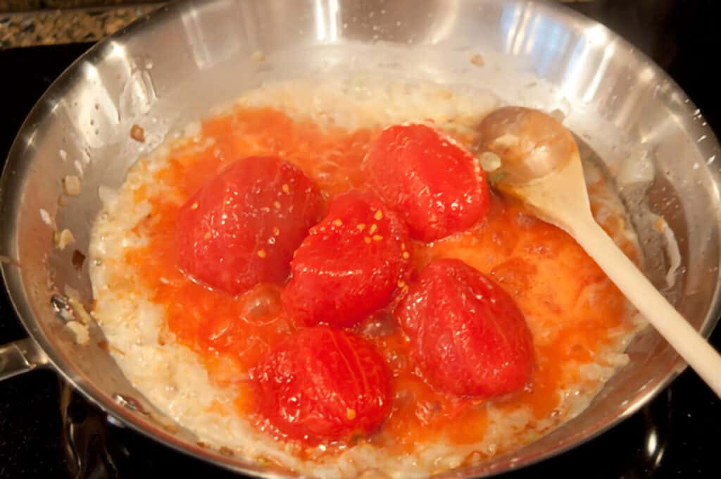 Tomatoes added to the flour and onions.