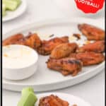 Finished buffalo wings on a serving plate.