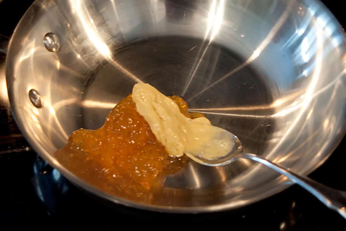 Small skillet containing peach preserves and Dijon mustard for dipping sauce.