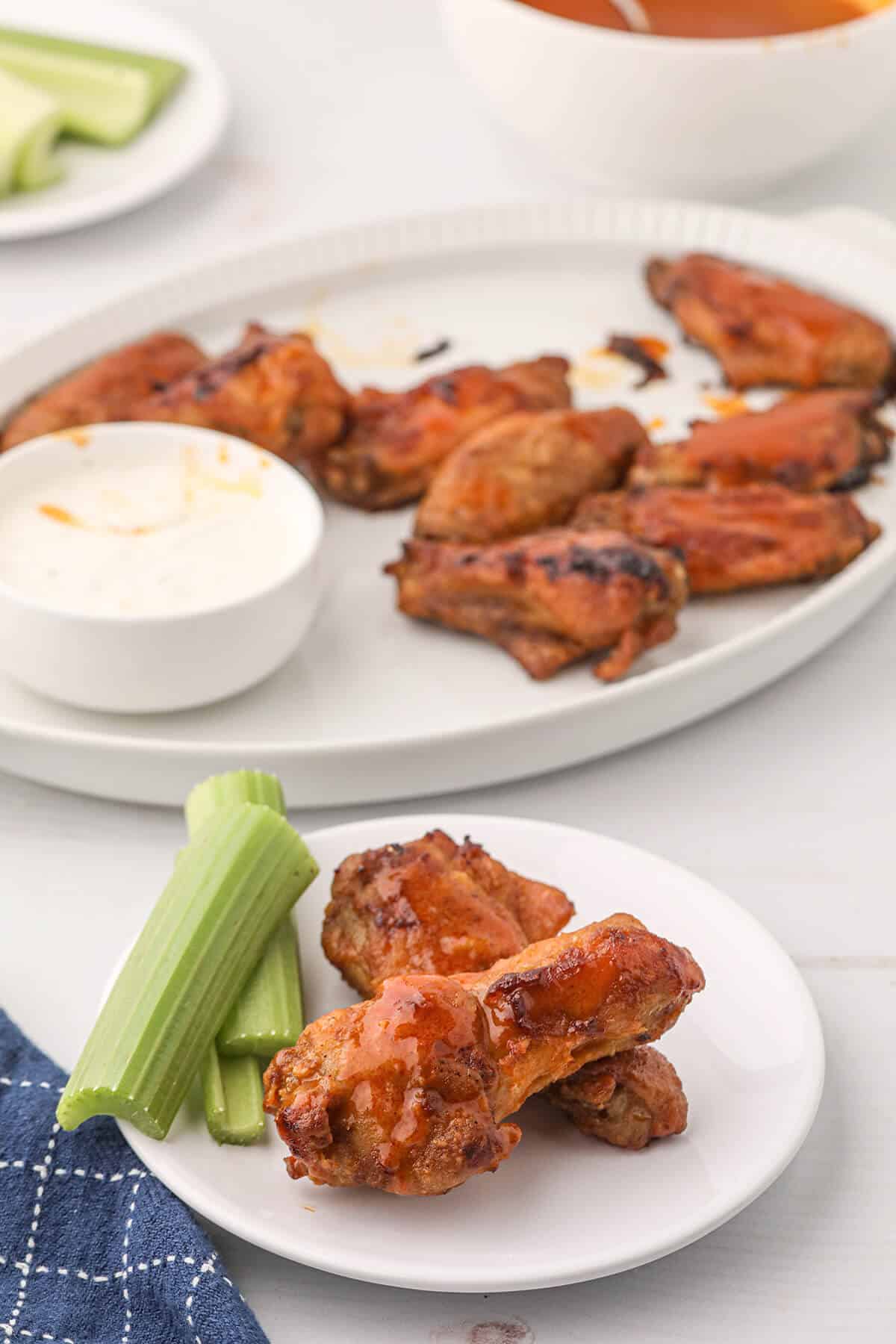 Finished buffalo wings on a serving plate.