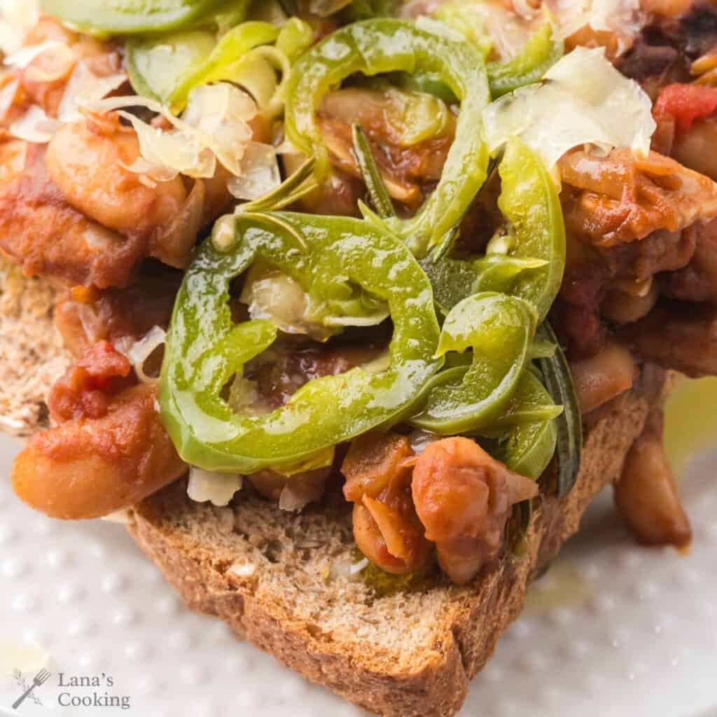 British-style beans on toast on a white plate, ready to be served.