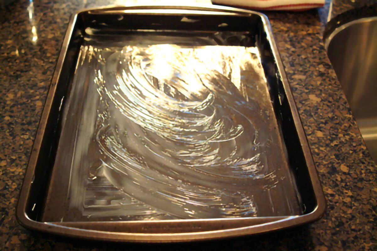 Baking sheet prepared with butter.