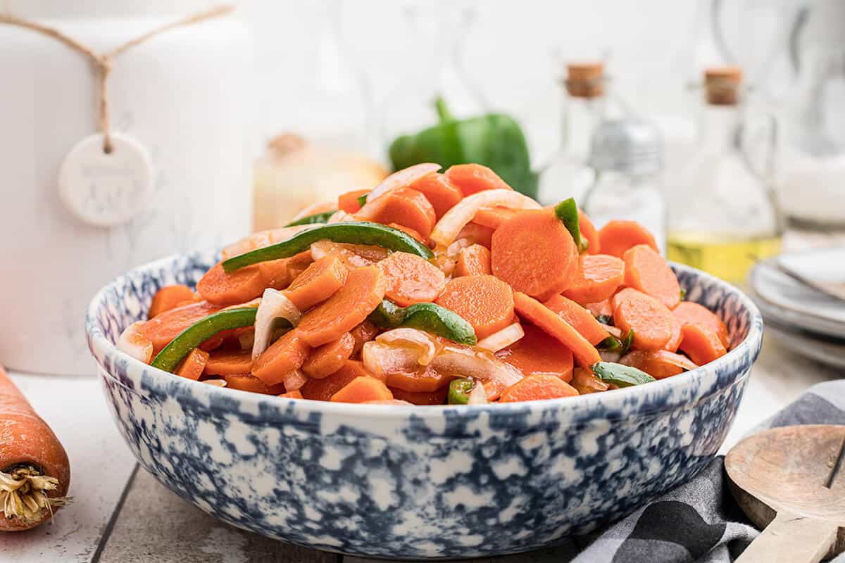 Copper pennies marinated carrot salad in a blue and white serving bowl.