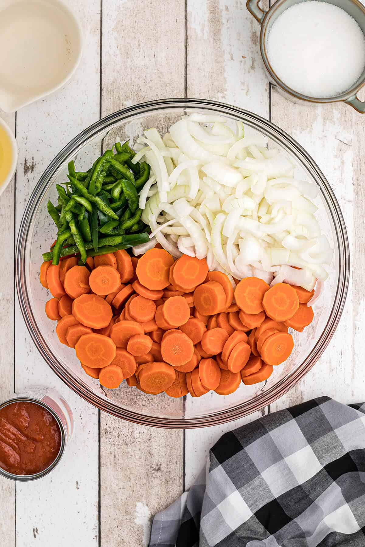 Carrots, onions, and peppers in a bowl.
