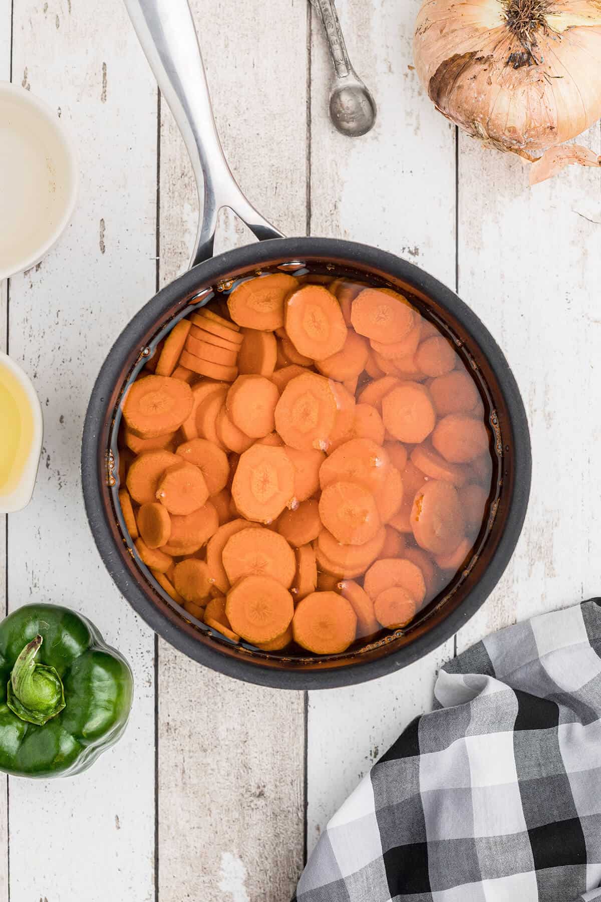 Carrots in water in a saucepan.