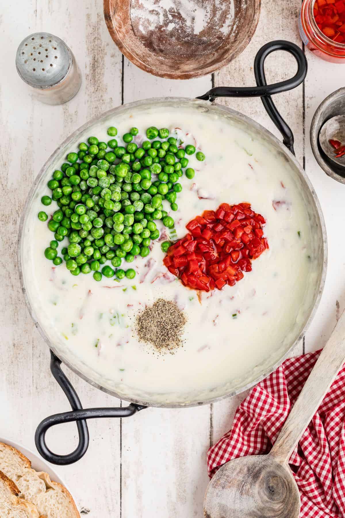 Peas, pepper, and pimento pieces added to the beef and onion sauce.