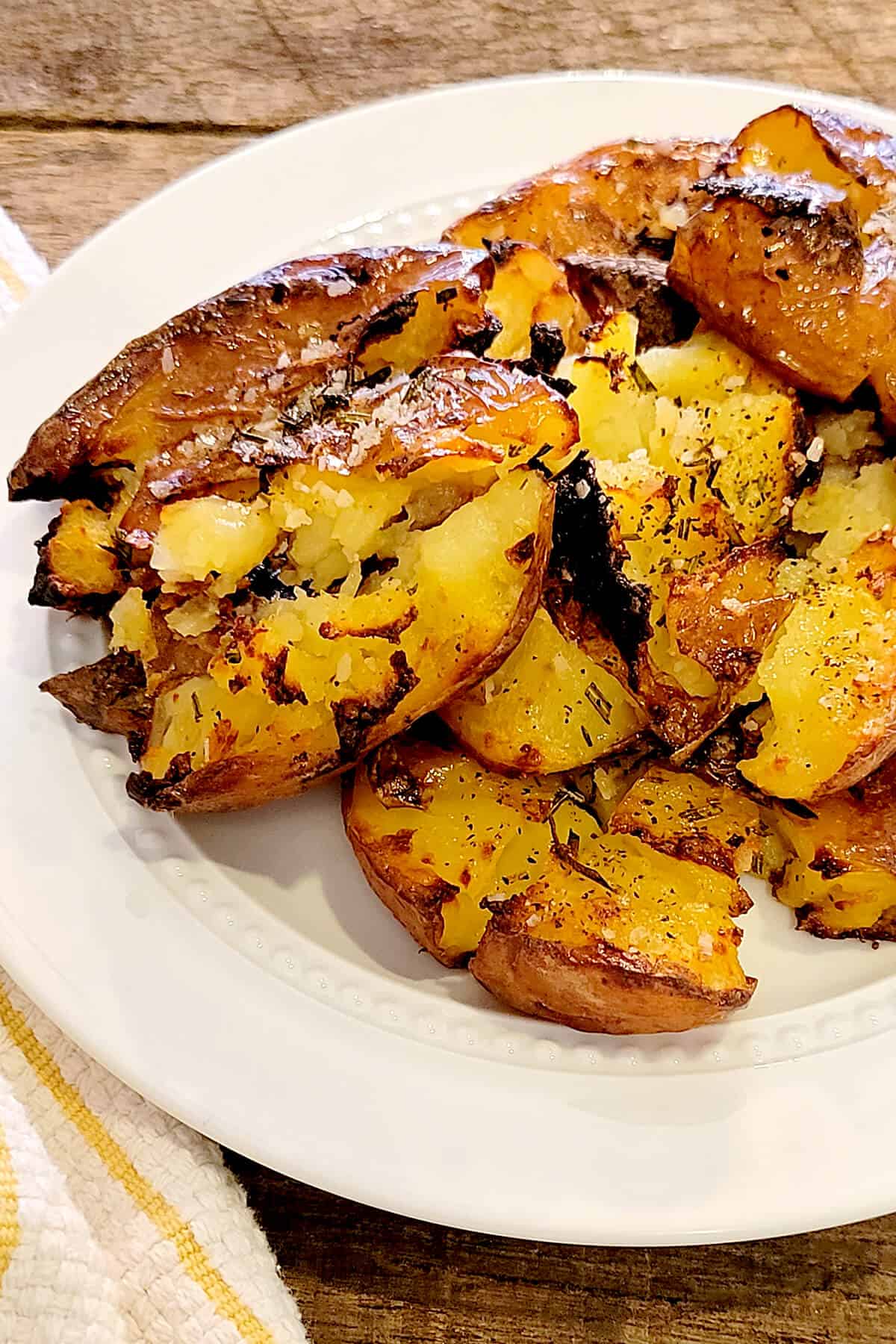 Crispy smashed potatoes on a serving plate.
