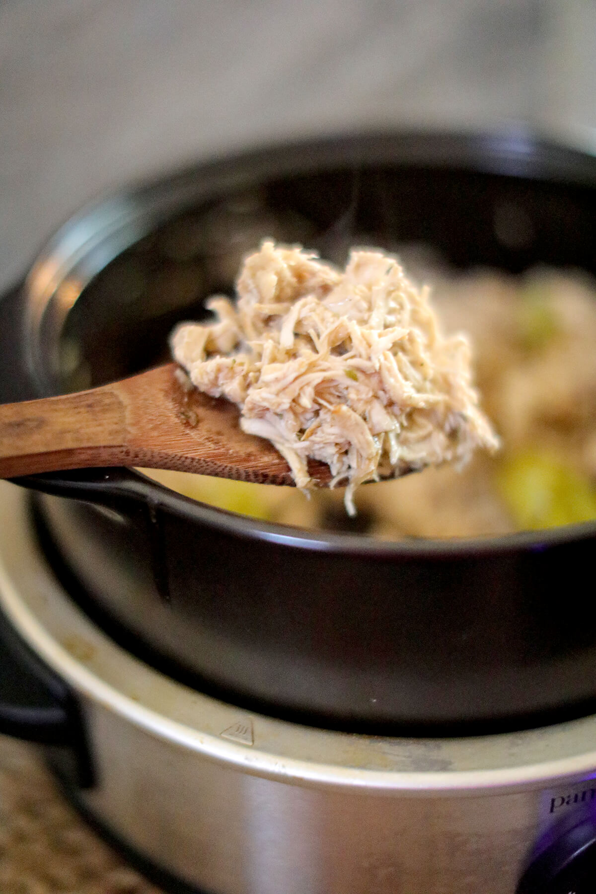 Shredded chicken added back to slow cooker.