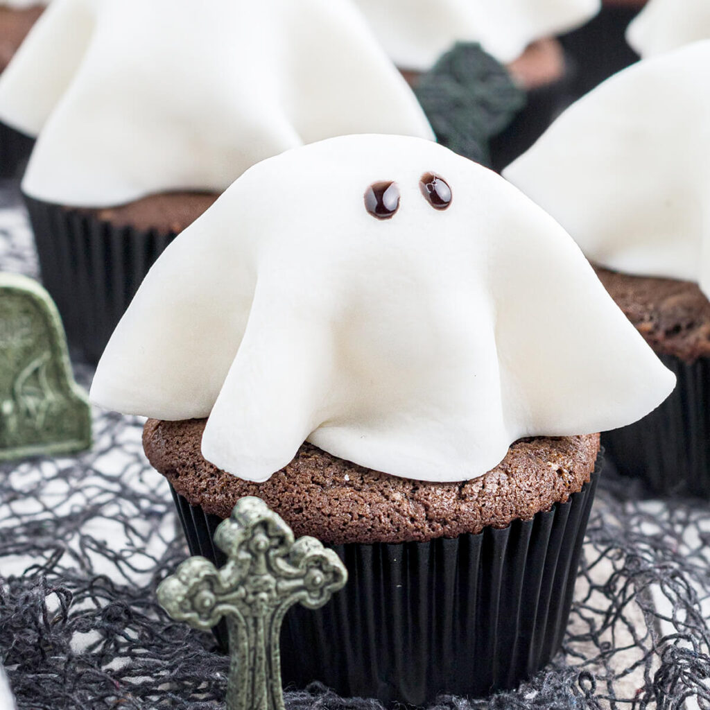 Finished ghost cupcakes on a serving tray.