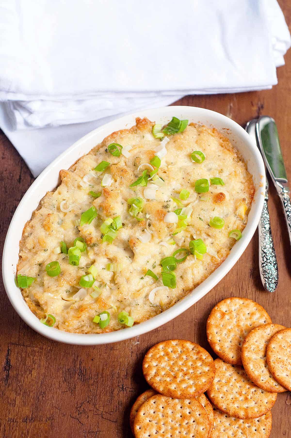 Finished hot artichoke dip in a baking dish.