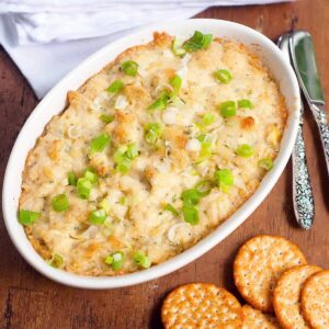 Finished hot artichoke dip in a baking dish.