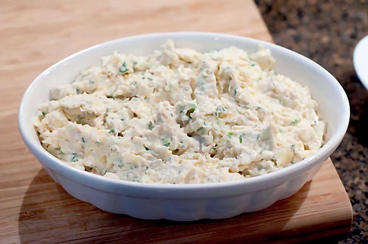 Hot Artichoke Spread ready to bake Dip mixture in a baking dish.