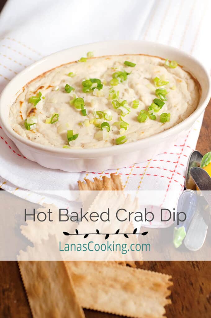Crab dip in a baking dish with crackers on the side.