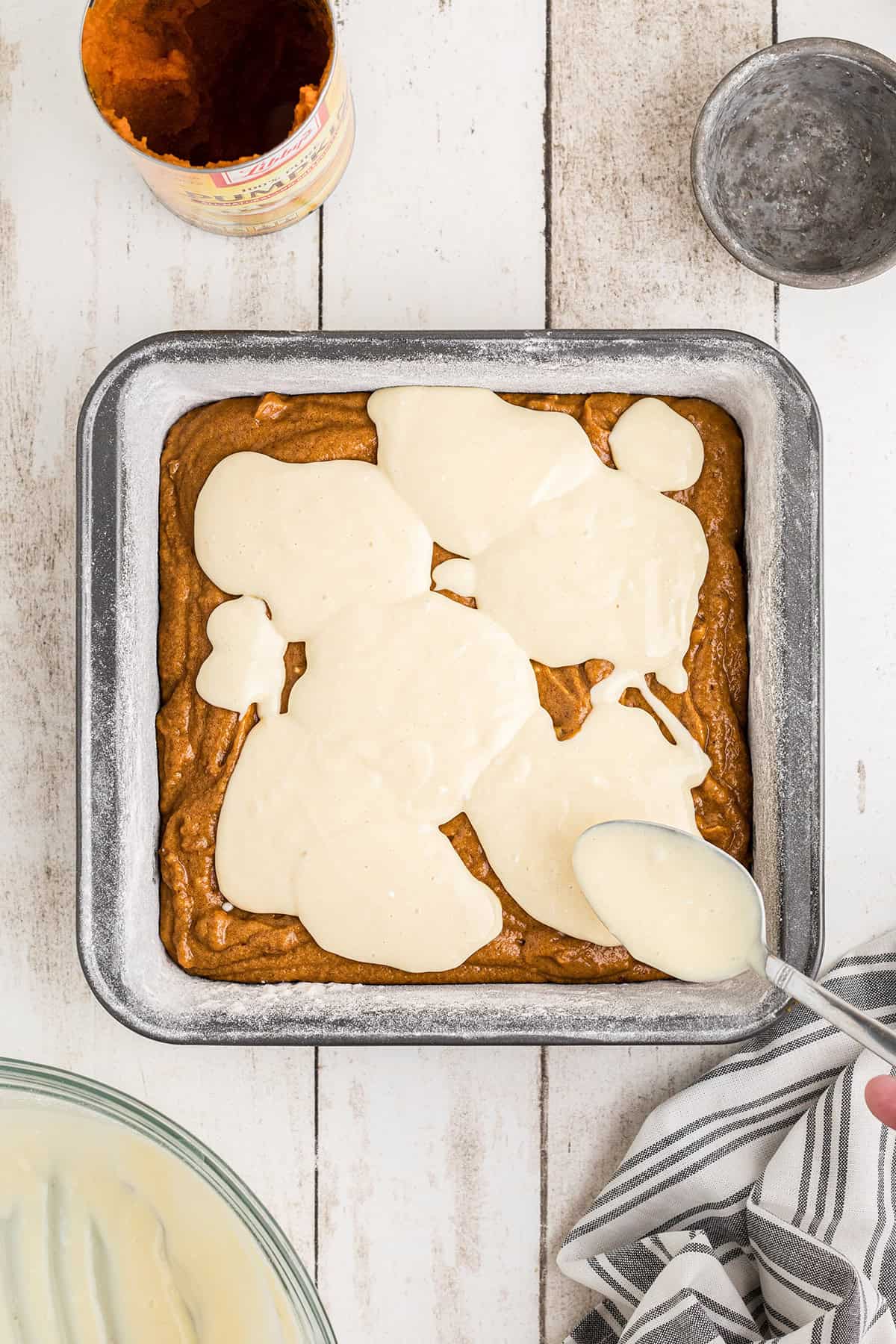 Dollops of cream cheese added to top of brownie mixture.