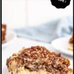 A slice of pecan cheesecake pie on a white serving plate.