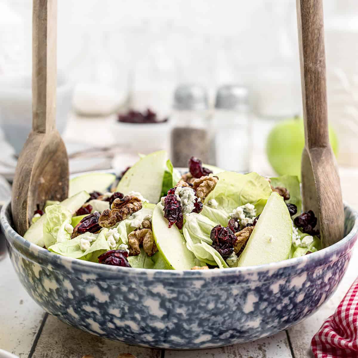 Tossing the salad in a bowl.