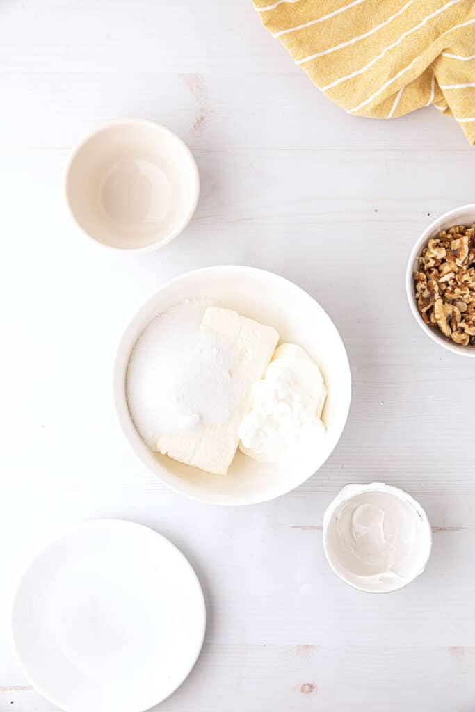 Cream cheese, sour cream, and sugar mixture in a bowl.