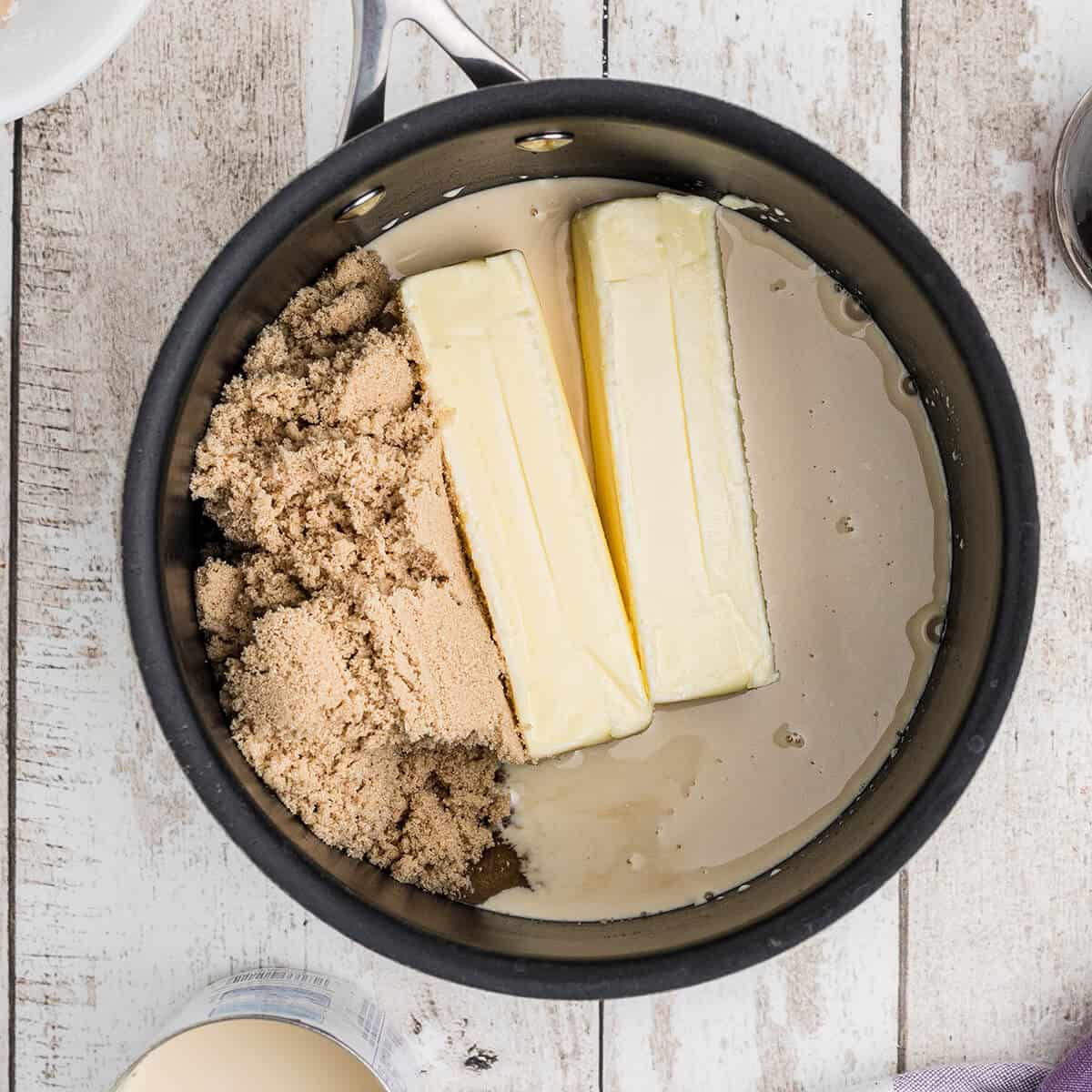 Butter, brown sugar, and evaporated milk in a saucepan.