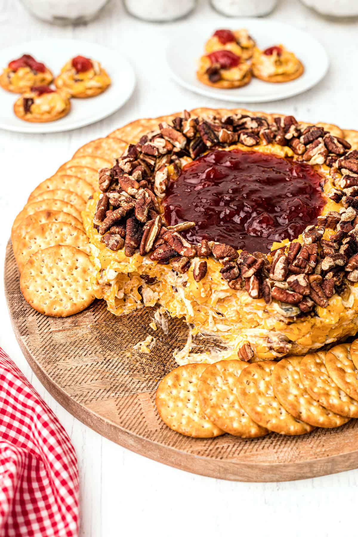 Cheese ring surrounded by crackers on a serving board.