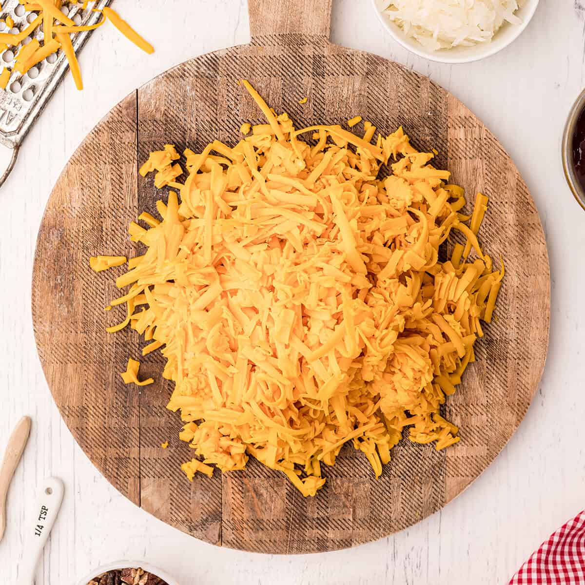 Grated cheese on a wooden board.