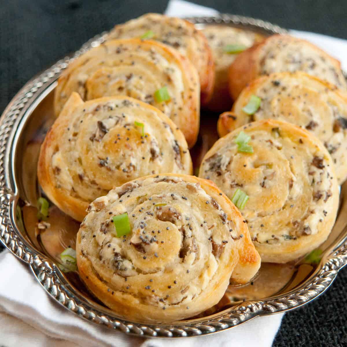 Mushroom pinwheels on a silver tray.