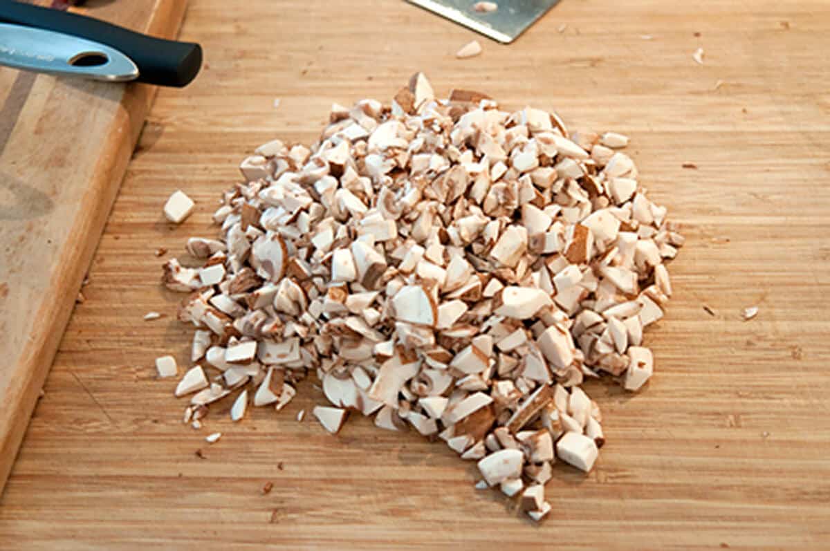 Minced mushrooms on a cutting board.