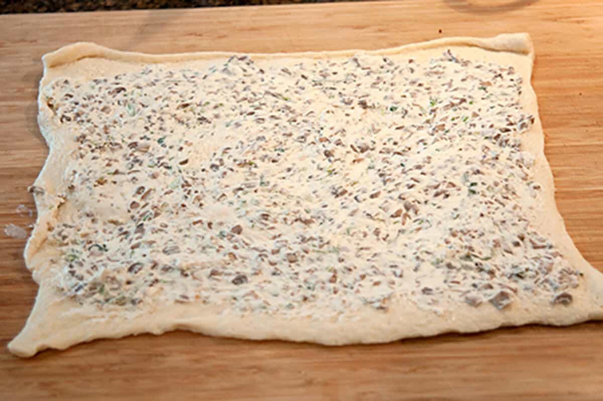 Refrigerated pizza crust spread with mushroom and cream cheese mixture.