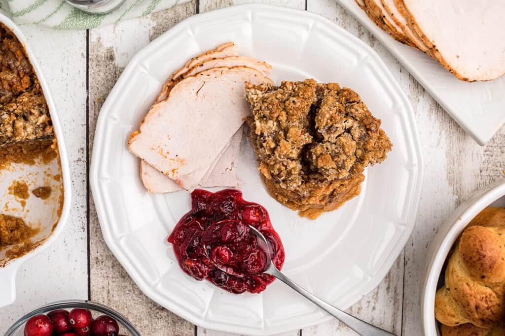Cranberry orange relish on a plate with turkey and stuffing.