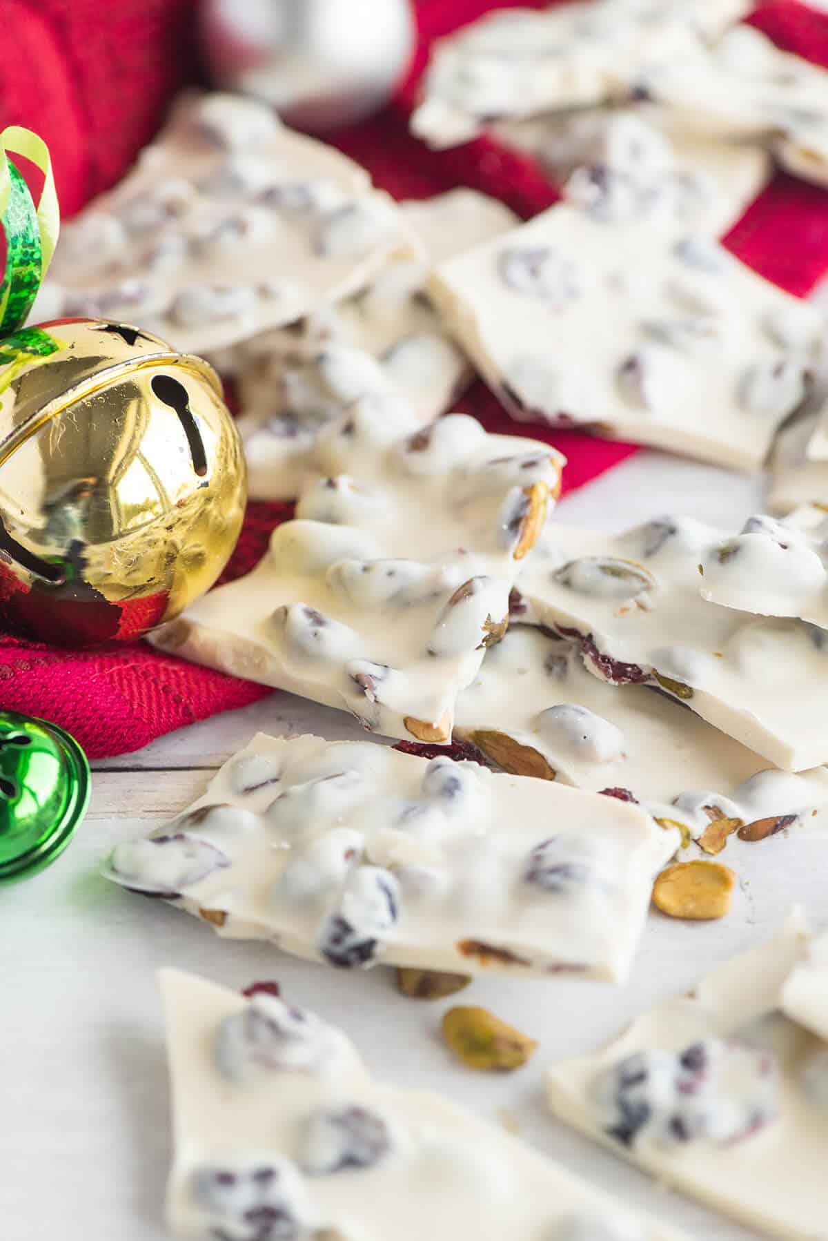 White chocolate bark pieces spread out with Christmas ornaments.