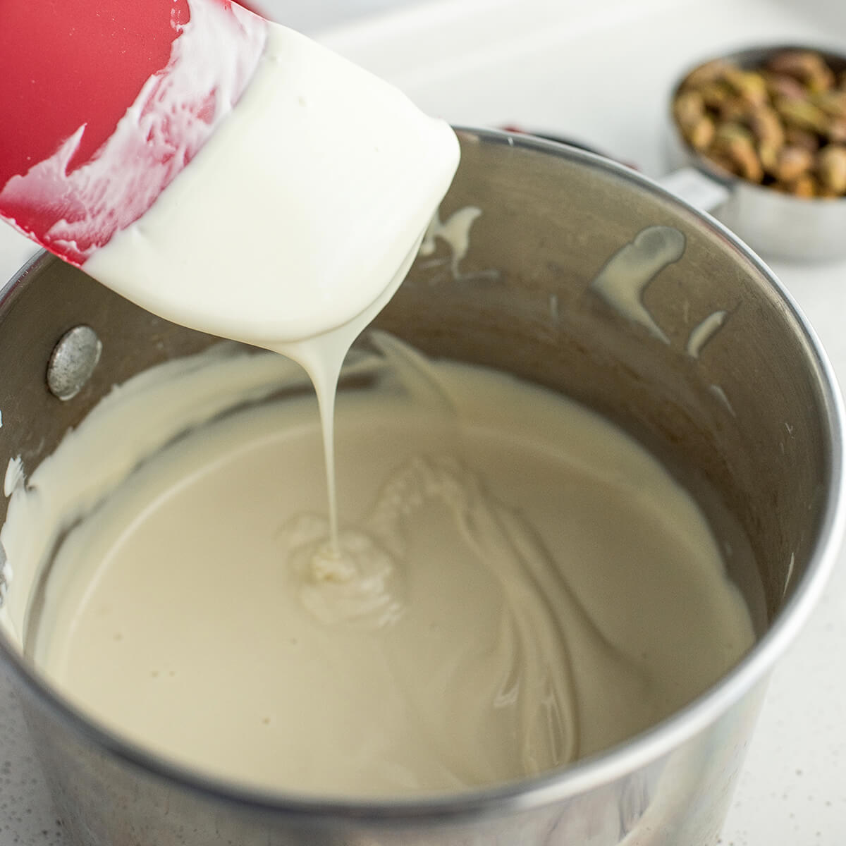 Melted white chocolate in a saucepan.