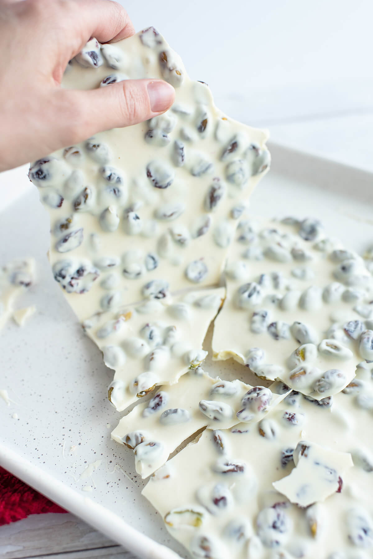 Breaking white chocolate bark into pieces.