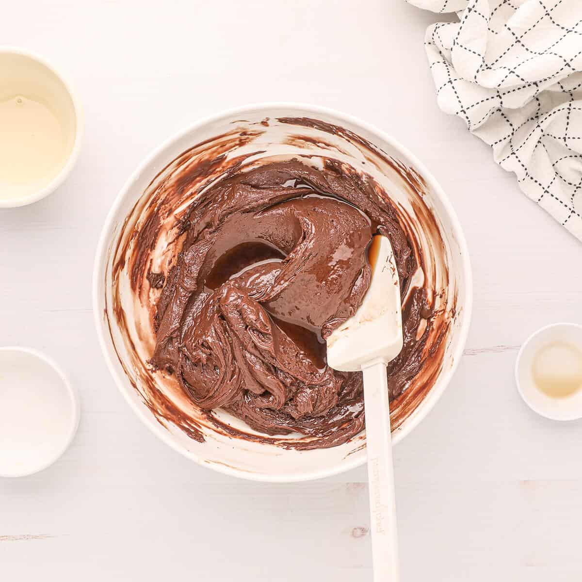 Butter and melted chocolate stirred together in a bowl.