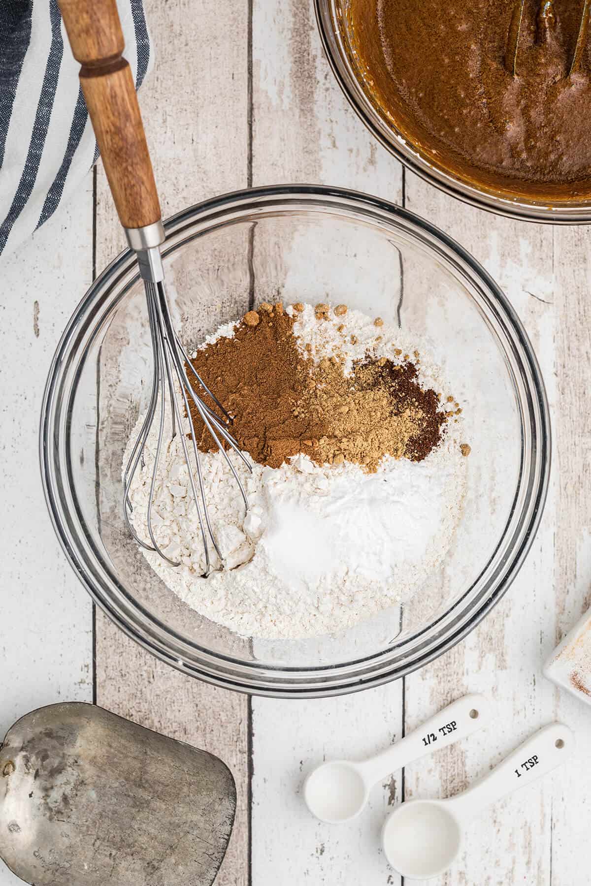 Combining flour and spices in a mixing bowl.