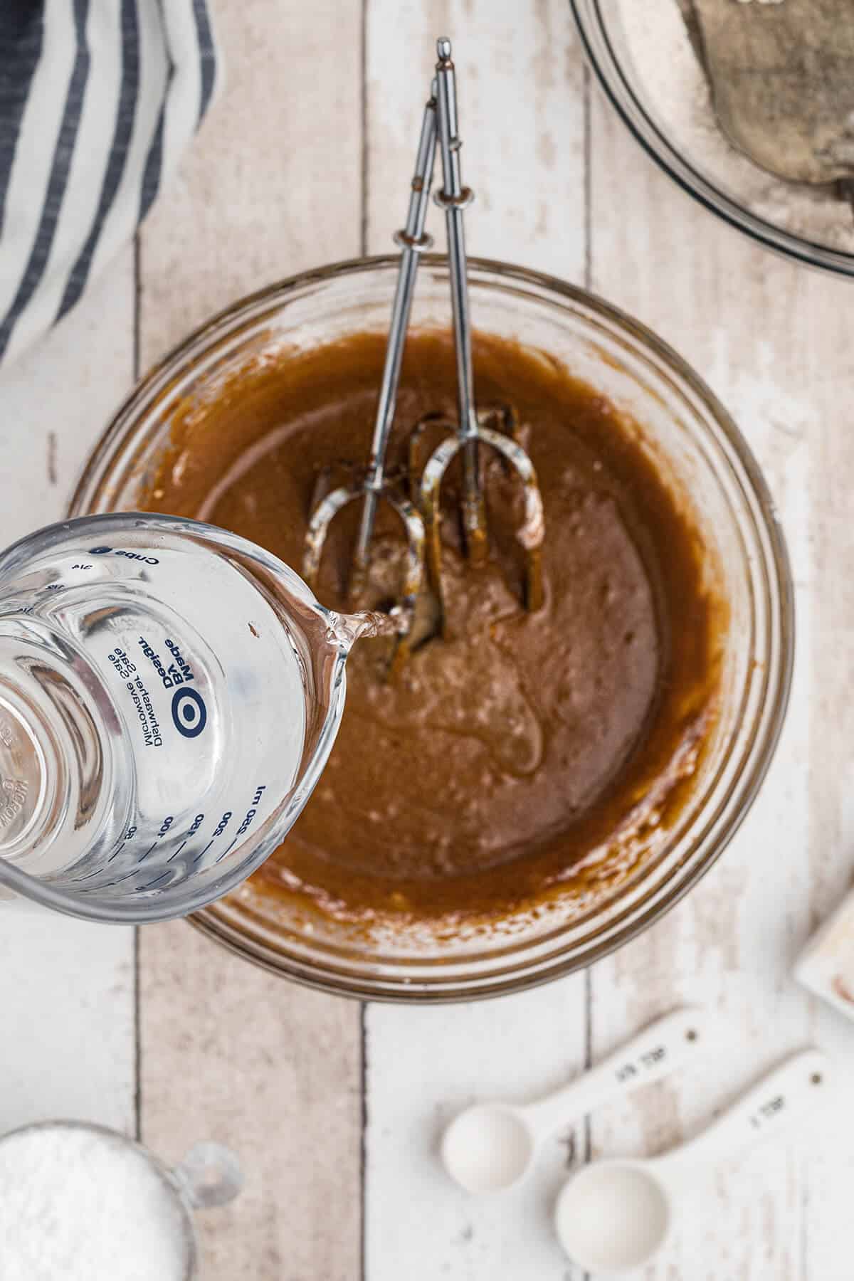 Adding water to batter.