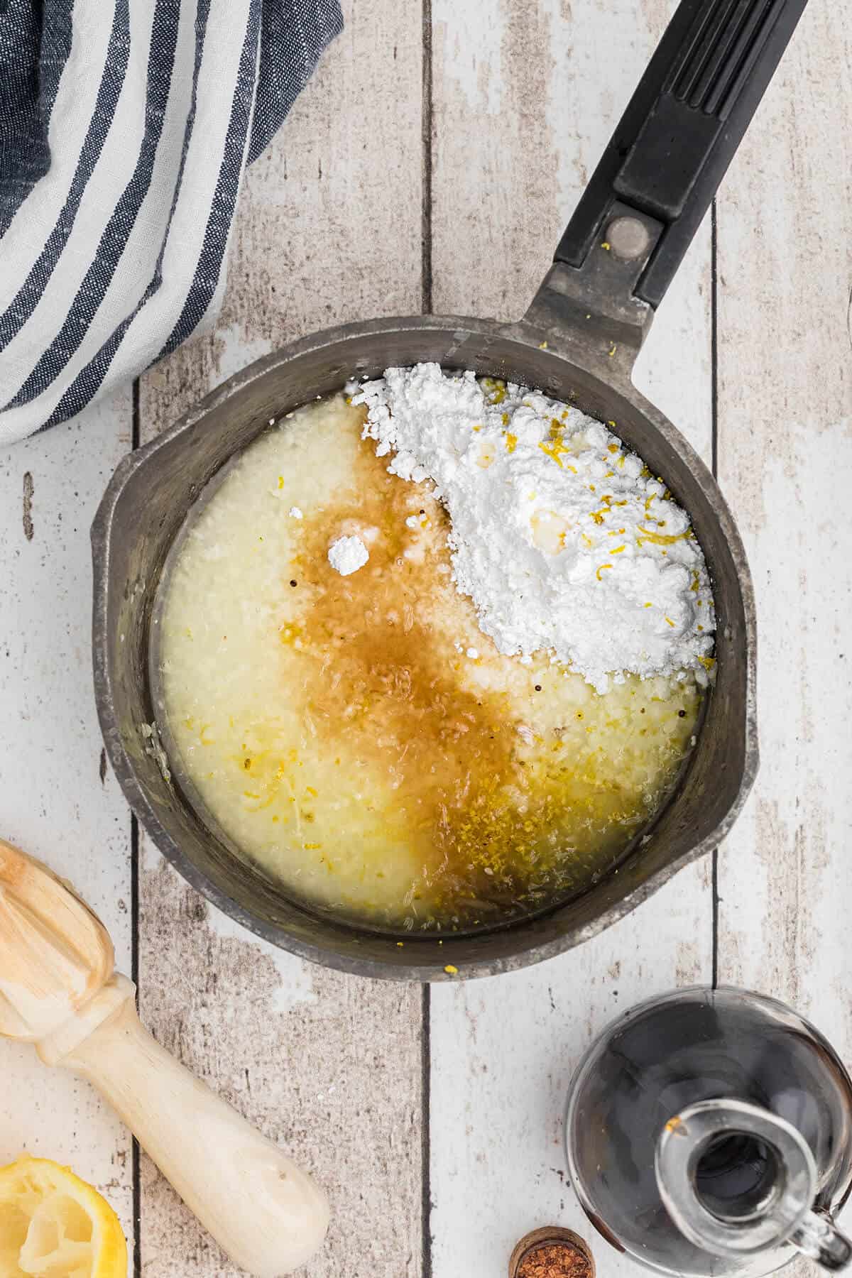 Ingredients for lemon glaze in a small saucepan.