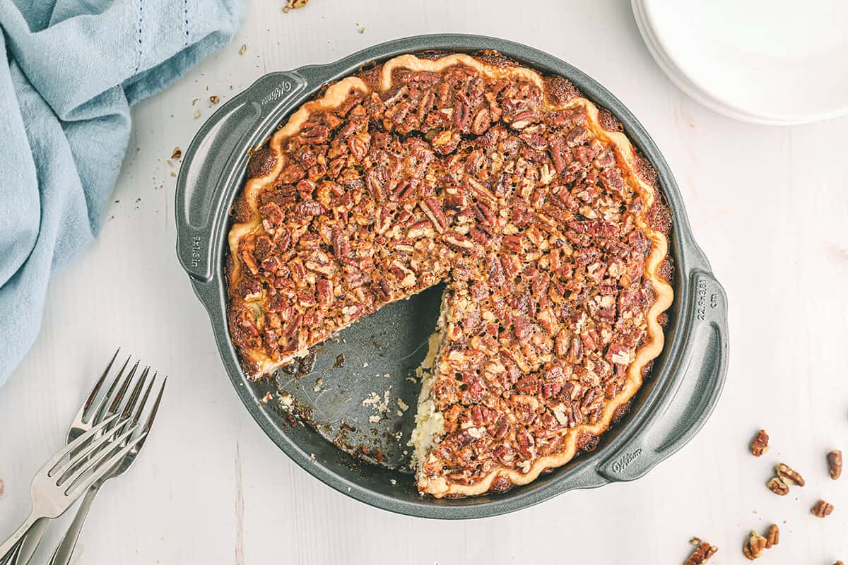 Pecan cheesecake pie in a pie plate.