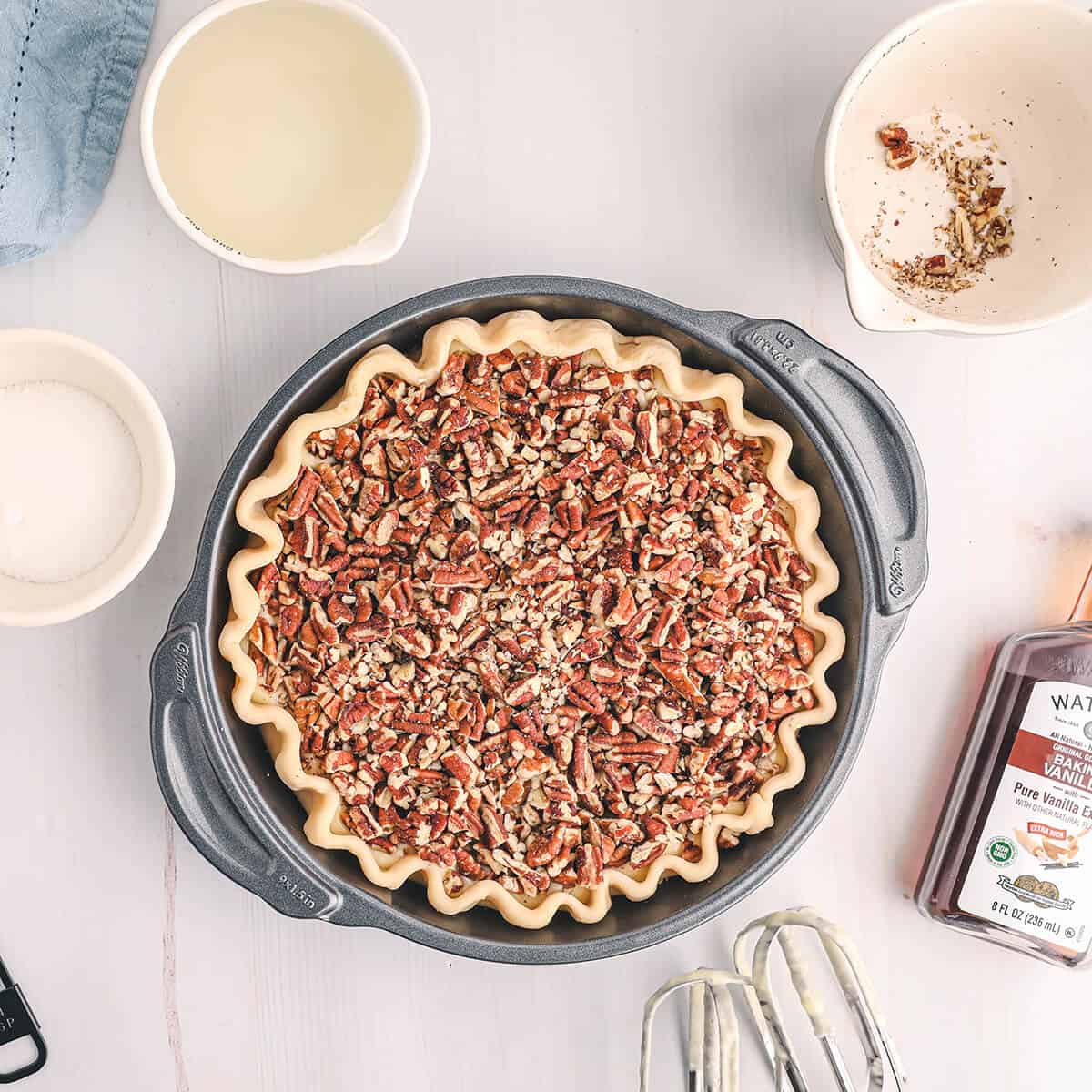 Chopped pecans sprinkled evenly over the cream cheese layer.