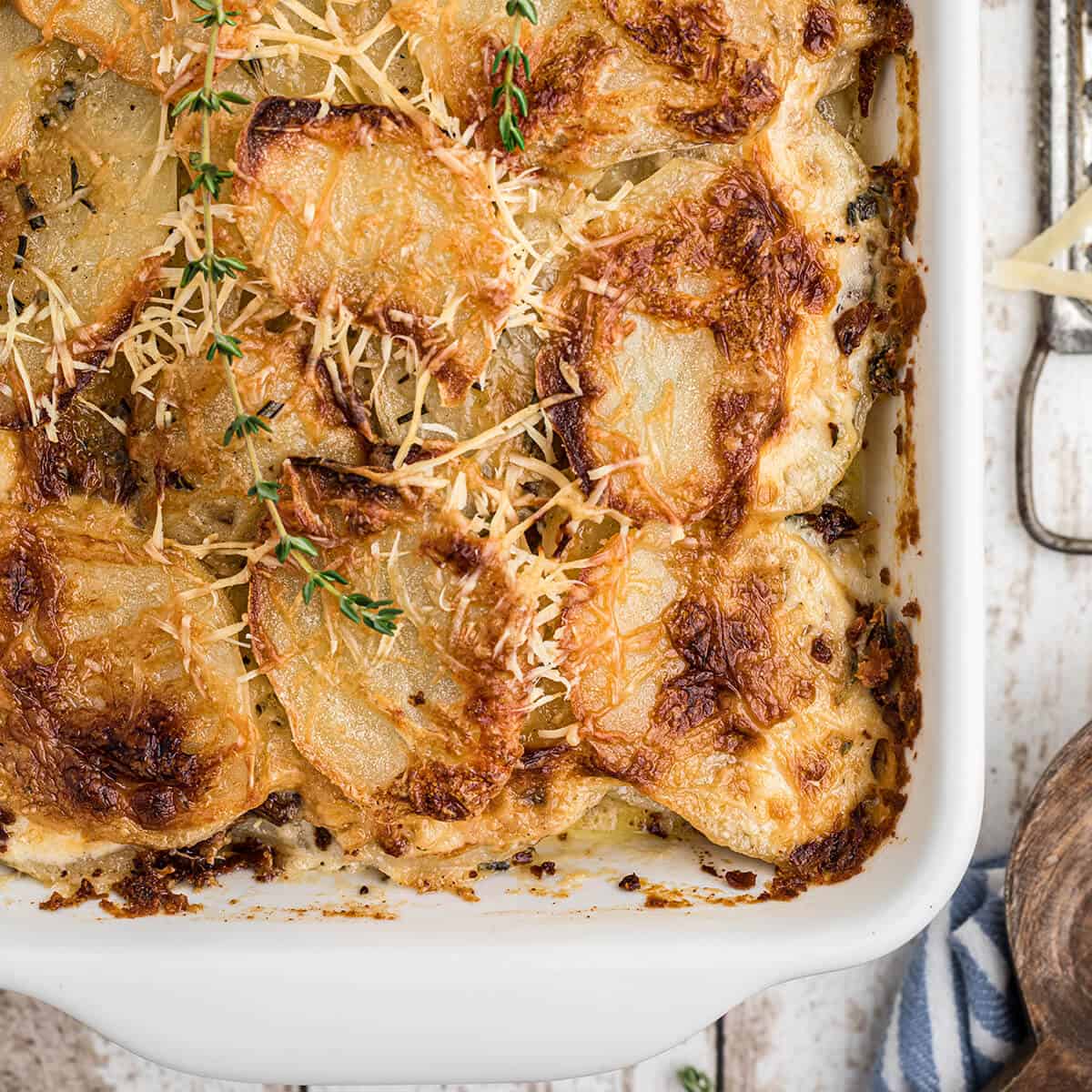 Finished potatoes au gratin in a white baking dish.