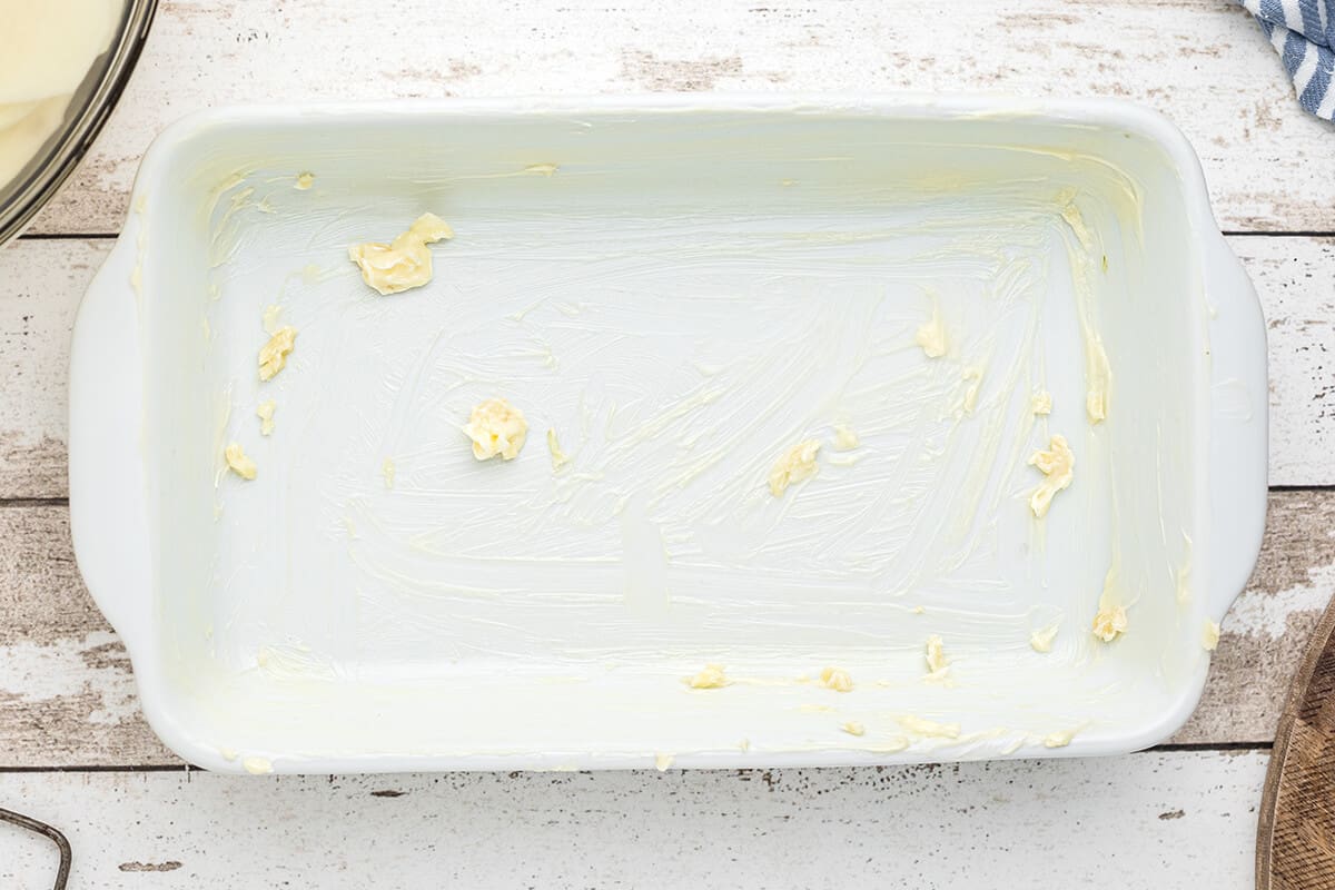 Butter inside of a baking dish.