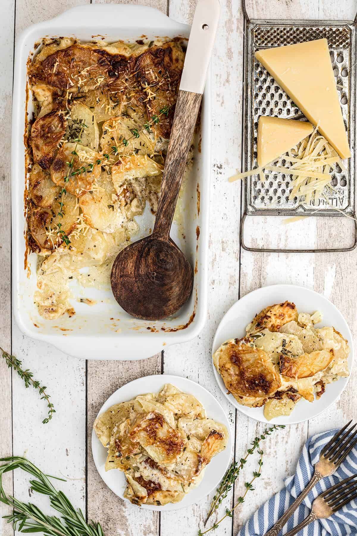 Finished potatoes au gratin in a white baking dish.