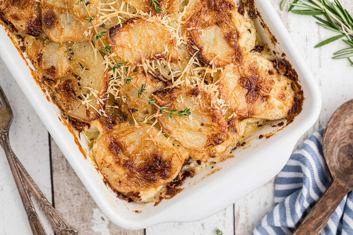 Finished potatoes au gratin in a white baking dish.