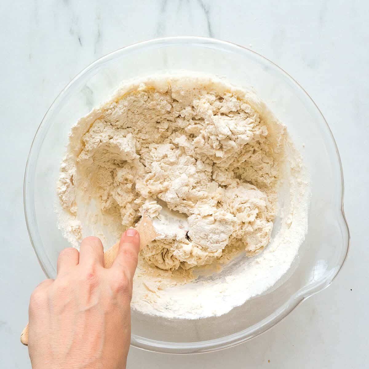 Mixing proofed yeast with flour.