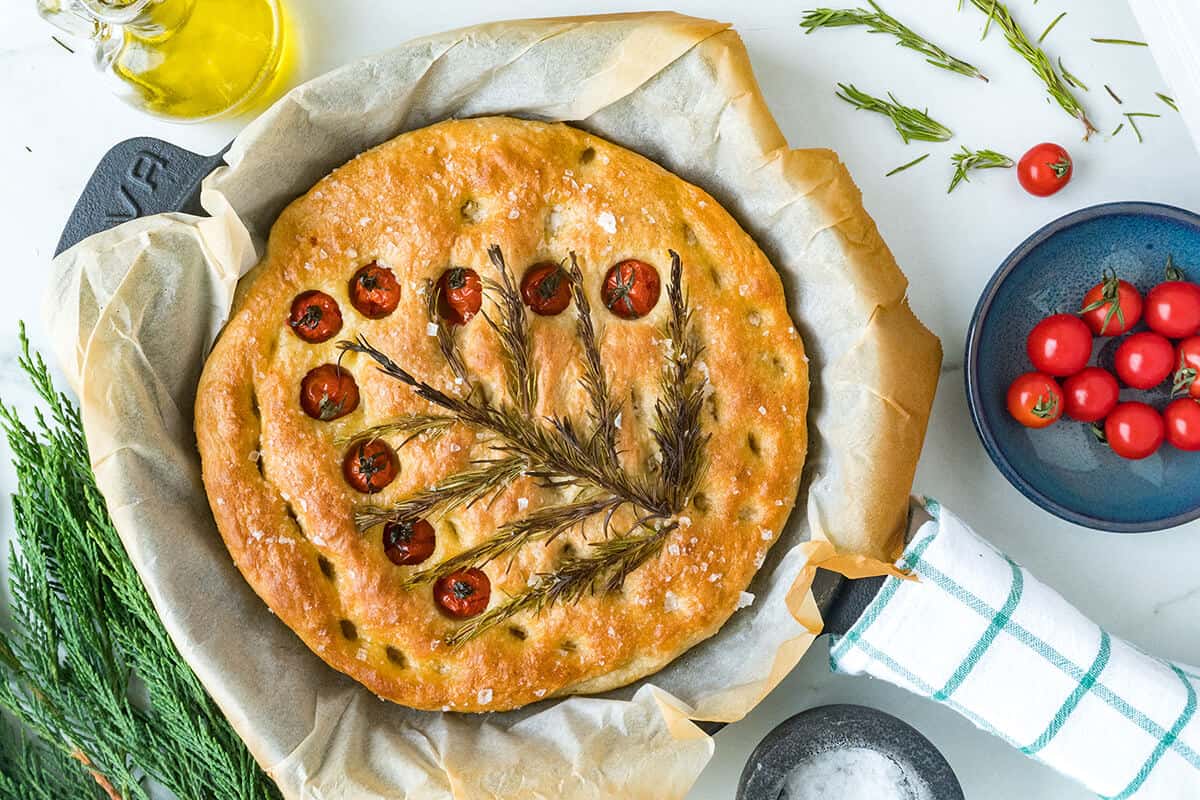 Finished christmas tree focaccia in a skillet with parchment paper.